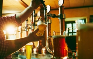 A person pouring a beer at one of the breweries in Newport.