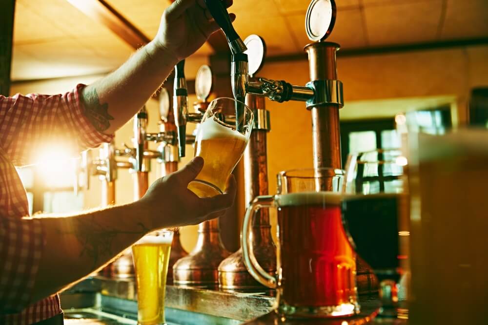 A person pouring a beer at one of the breweries in Newport.